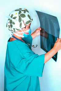 Side view of boy wearing mask holding medical x-ray