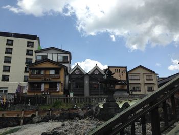 Buildings against cloudy sky