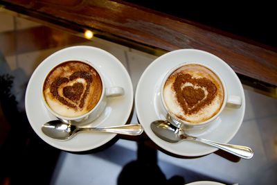 High angle view of coffee cups on table