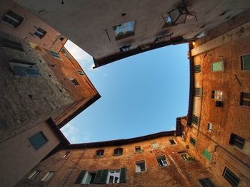 Low angle view of buildings against clear blue sky