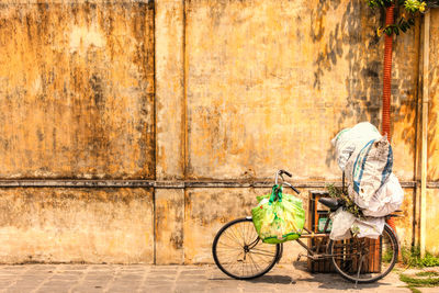 Sack on bicycle parking against wall