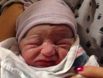 Close-up of baby sleeping on bed