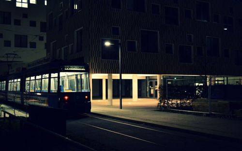 Railroad tracks in city at night