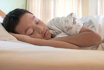 Young woman sleeping on bed at home
