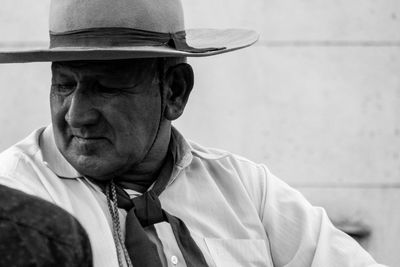 Man wearing hat while looking away outdoors