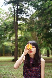 Portrait of young woman holding flower