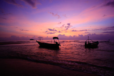 Silhouette boat in sea against sky during sunset