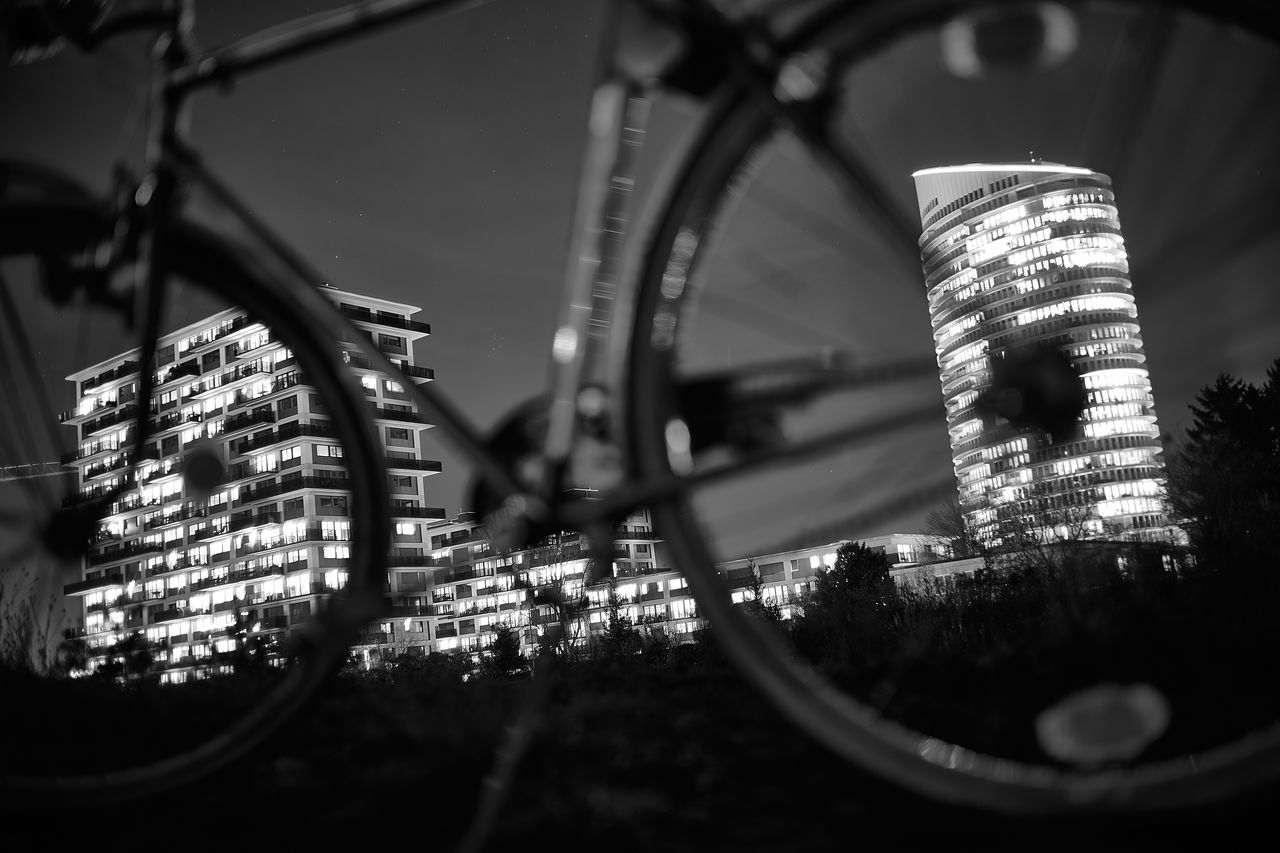 black, black and white, light, architecture, built structure, darkness, white, no people, monochrome, monochrome photography, transportation, selective focus, city, close-up, building exterior, outdoors, wheel, nature, night