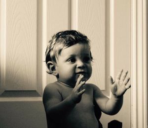 Portrait of boy standing at home