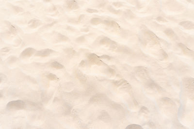 Full frame shot of paper on sand