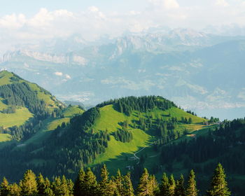 Scenic view of trees and mountains against sky