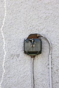 Close-up of electric lamp on wall