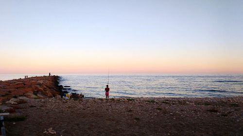 Scenic view of sea against clear sky during sunset