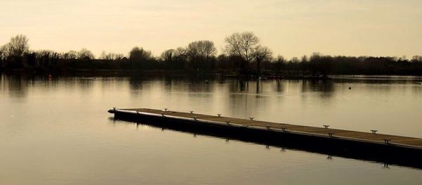 Scenic view of calm lake at sunset