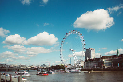 Ferris wheel in city against sky