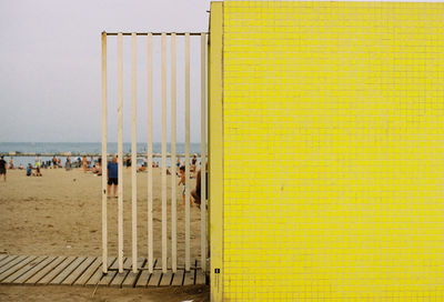 View of beach hut against yellow wall