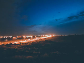 Illuminated city against sky at night