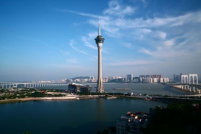 Macau tower amidst sea against sky