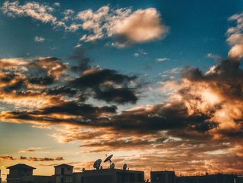 Low angle view of built structure against cloudy sky