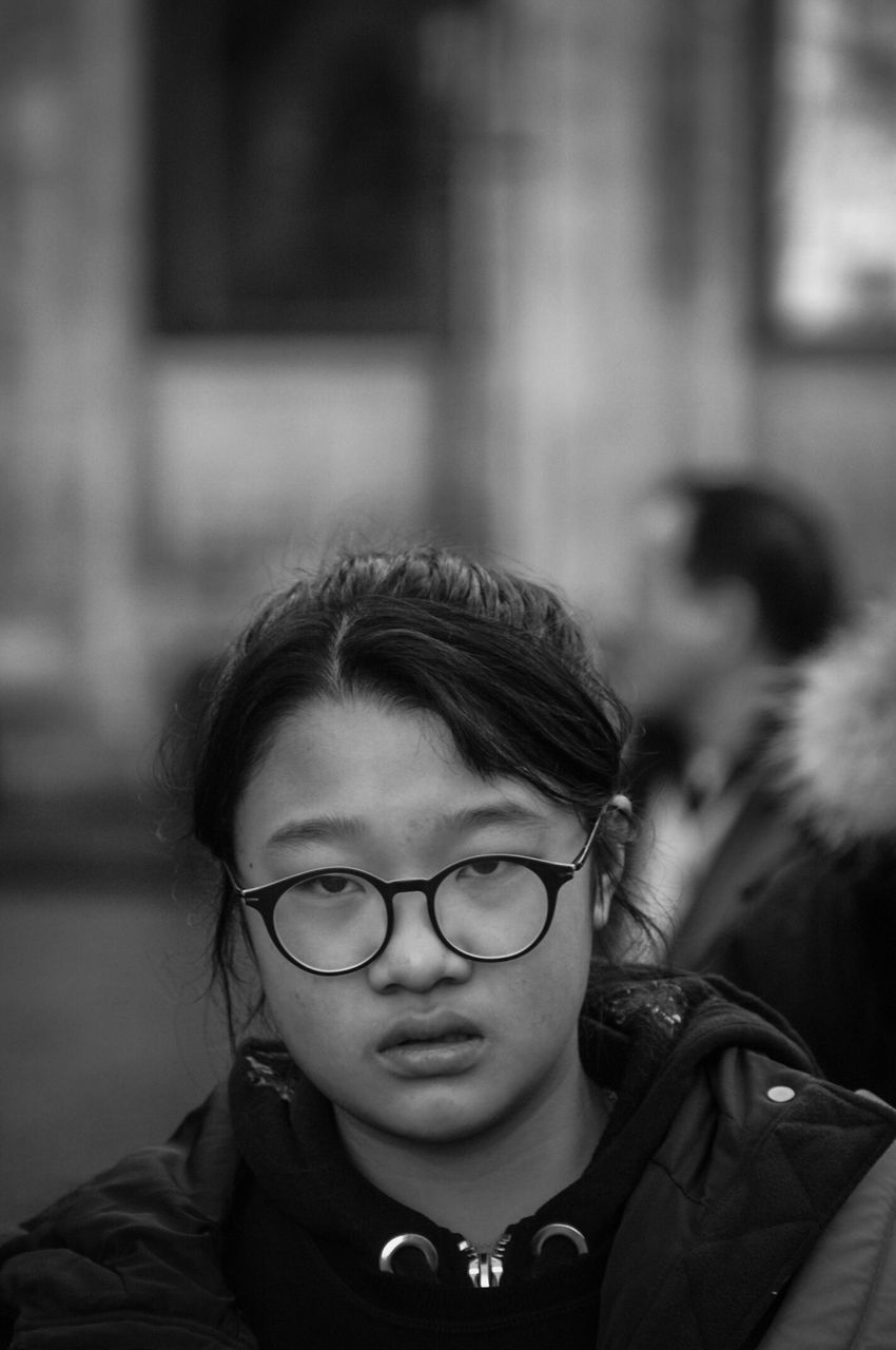 eyeglasses, portrait, headshot, glasses, real people, one person, focus on foreground, lifestyles, looking at camera, child, front view, females, childhood, leisure activity, women, close-up, girls, innocence, warm clothing, contemplation