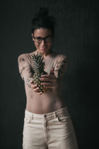 Midsection of woman standing against black background