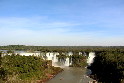 Scenic view of waterfall against sky