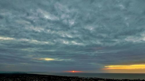 Scenic view of dramatic sky over sea during sunset