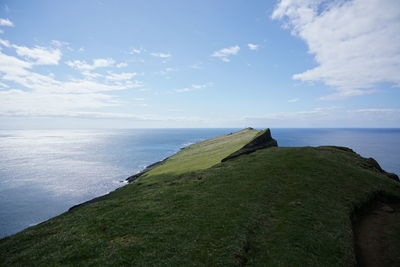 Scenic view of cliff against sea and sky