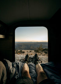 Pov view of legs out of camper door looking at desert landscape, utah
