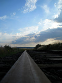 Railroad track amidst trees against sky