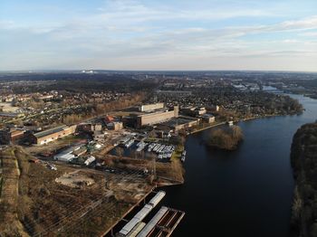 High angle view of townscape by sea against sky