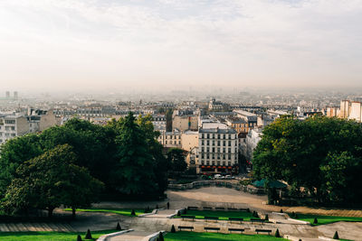 High angle view of buildings and trees against sky