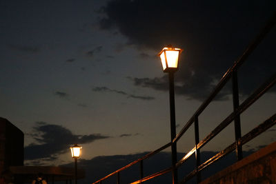 Low angle view of illuminated street light against sky at night