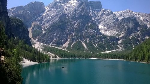 Scenic view of lake by mountains against clear sky