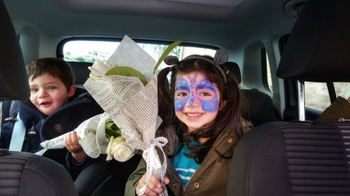 Two children holding flowers