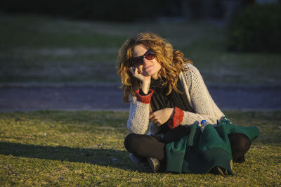 Young woman sitting on field