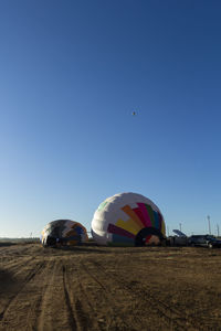 View of hot air balloon flying over land