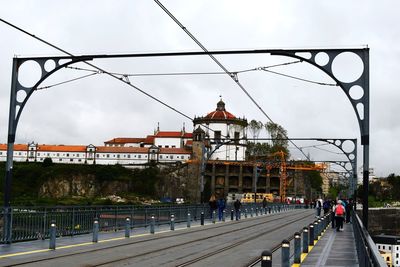 View of bridge in city against sky