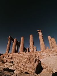 Low angle view of old ruins against clear sky