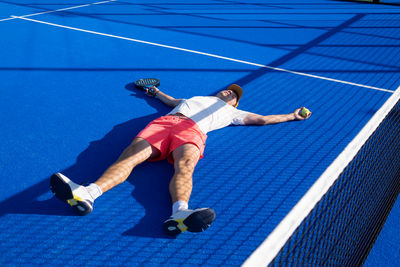 Low section of man playing tennis