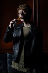 Young woman wearing mask while sitting at home