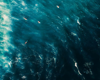 Blue background with surfers. drone photography water texture from the caribbean sea.