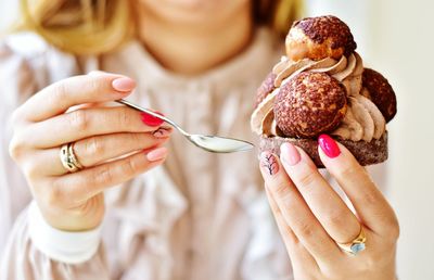 Midsection of woman holding ice cream