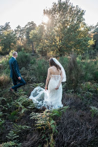 Newlywed couple walking in forest