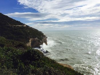 Scenic view of sea against cloudy sky