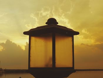 Silhouette built structure against sky during sunset