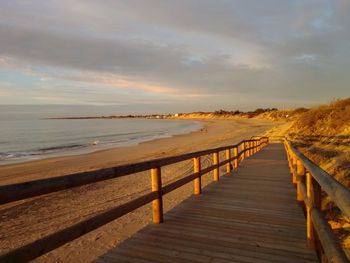 Scenic view of beach against sky during sunset