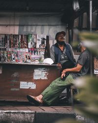 Portrait of young man standing at market