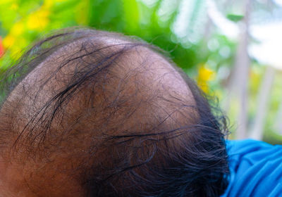 Close-up portrait of woman with palm leaf