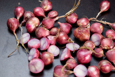 Red onions on black table